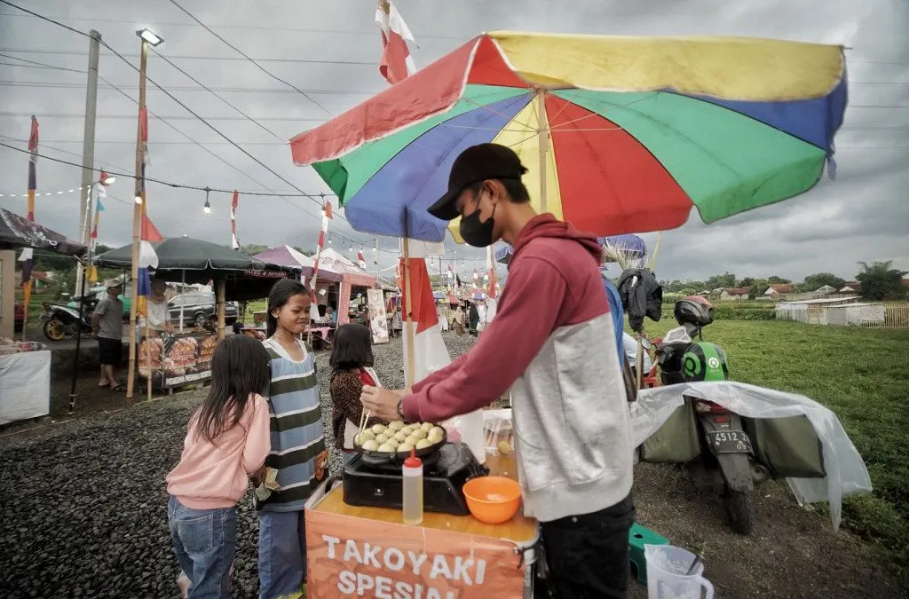 Warga ngabuburit di Kampung Ramadan Bunut, Margahurip, Kabupaten Bandung, Jumat 31 Maret 2023. Kampung Ramadan Bunut diinisiasi oleh Yayasan Cerebrum bersama Karang Taruna Bunut 09 dan menghadirkan bazzar makanan dari 103 UMKM makanan, minuman, hingga fesyen. 