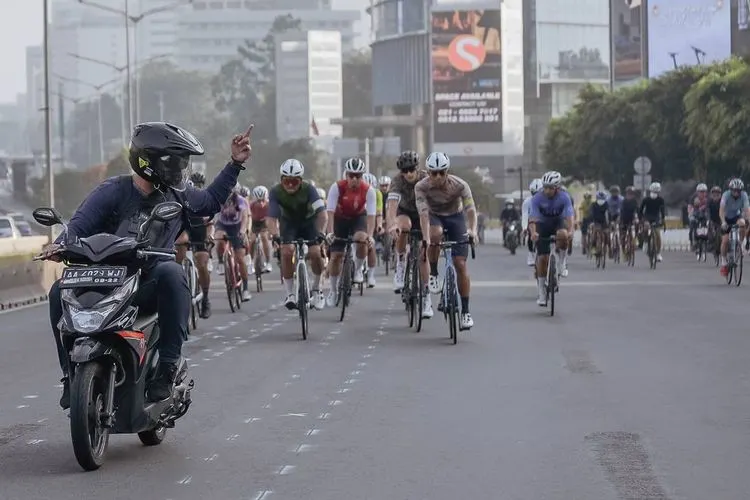 Rombongan pesepeda road bike melintasi lajur kanan jalan raya yang mendapat acungan jari tengah dari pemotor/dok: Instagram @goshow.cc