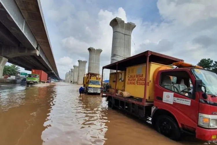Kendaraan menerjang banjir di Km 19 Jalan Tol Jakarta-Cikampek, Sabtu (20/2/2021).[Dok/Jasa Marga]