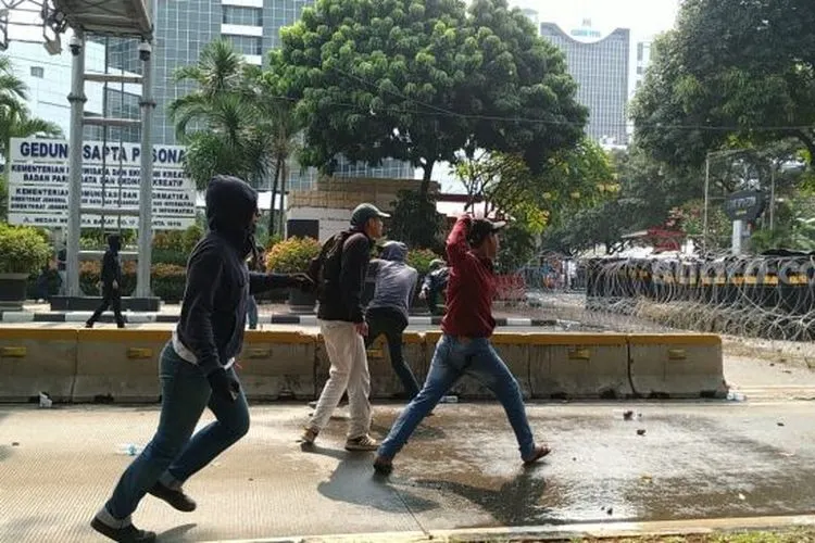 Massa pelajar penolak Omnibus Law bentrok dengan aparat di kawasan Patung Kuda. (Suara.com/M Yasir)