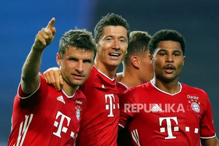Serge Gnabry (kanan) merayakan dengan rekan setimnya Thomas Mueller (kiri) dan Robert Lewandowski (tengah) setelah mencetak keunggulan 2-0 pada pertandingan semifinal Liga Champions antara Olympique Lyon dan Bayern Munich di Lisbon, Portugal, pada Rabu (19/8). ( Foto: Miguel A. Lopes / POOL/EPA POOL)