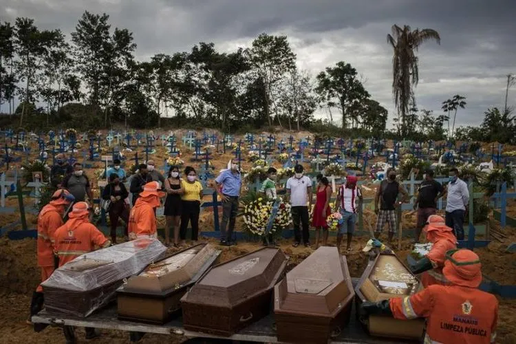 Keluarga menghadiri pemakaman sejumlah korban meninggal Covid-19 di Manaus, Brasil, (23/4). (Foto: EPA)