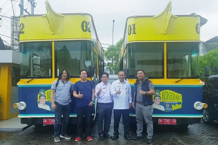 Tim Humas Hari Pers Indonesia (HPN) 2020 foto bersama dengan latar bus wisata Kalimantan Selatan di Banjarmasin (Humas HPN)