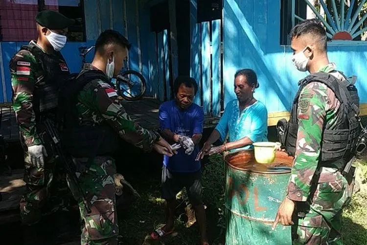 Prajurit Satgas Pamtas Yonif Raider 300/Brajawijaya (Bjw) di Pos Wambes mengajarkan cara mencuci tangan yang benar (Papen Satgas Raider 300, Lettu Inf Dody Suyono)