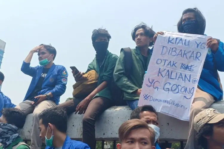 Seorang mahasiswa membawa poster yang isinya menyindir anggota DPR RI dalam demonstrasi besar-besaran pada Selasa lalu (24/9/2019)/Ayojakarta.com