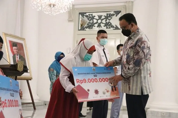 Gubernur DKI Jakarta, Anies Baswedan menyerahkan beasiswa pendidikan unutk anak tenaga eksehatan yang gugur karena Covid-19. (Sumber foto: Humas Pemprov DKI Jakarta)