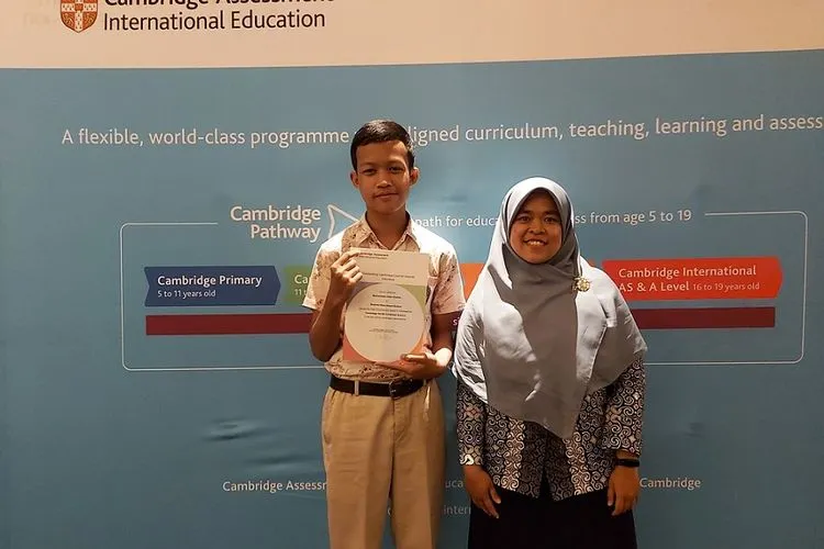 Muhammad Attar Khalifa, siswa kelas 9 dari Bosowa Bina Insani School di Bogor, Jawa Barat (kiri), penerima penghargaan ‘High Achievement’” di level IGCSE untuk Combined Science bersama guru pendampingnya, Listya Rahmawati (kanan). (BWC Global)