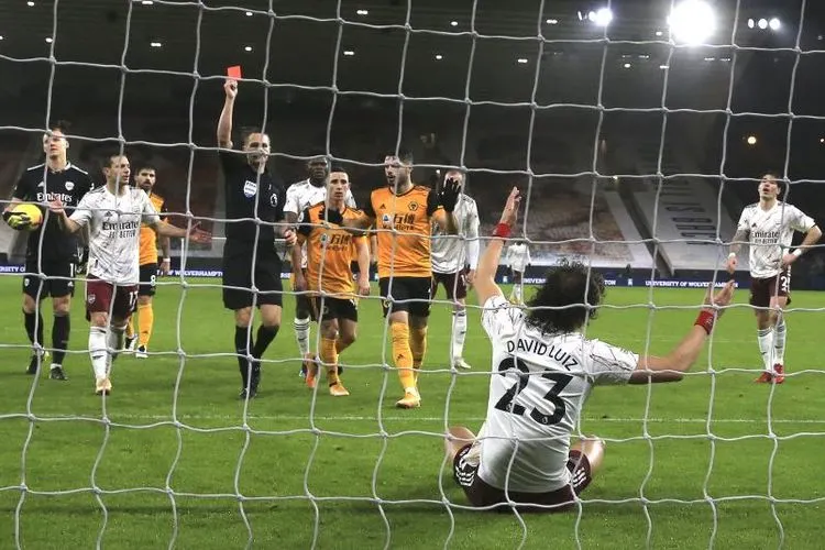 Pemain Arsenal David Luis mendapat kartu merah setelah melakukan pelanggaran terhadap pemain Wolves dalam pertandingan lanjutan Liga Inggris di Stadion Molineux, Rabu (3/2) dini hari WIB. Foto: EPA