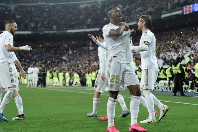 Pemain depan Real Madrid Vinicius Junior (C) merayakan golnya setelah mencetak gol selama pertandingan sepak bola Liga Spanyol antara Real Madrid melawan Barcelona di Stadion Santiago Bernabeu, Madrid, Spanyol, Senin (2/3) dini hari WIB. [OSCAR DEL POZO / AFP]