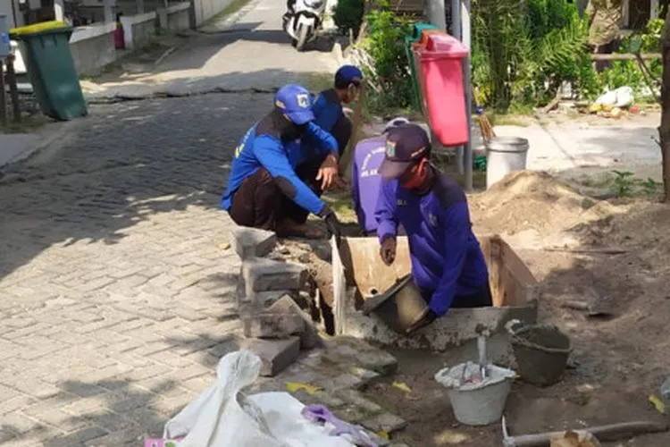 sejumlah petugas sedang mengerjakan pembangunan sumur resapan / beritajakarta.id