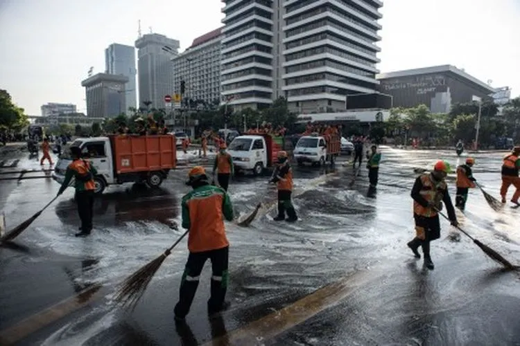 Petugas Penanganan Prasarana dan Sarana Umum (PPSU) membersihkan jalan pascakerusuhan di kawasan Kantor Bawaslu, Jakarta, Kamis (23/5/2019). ANTARA FOTO/Aprillio Akbar/foc.
