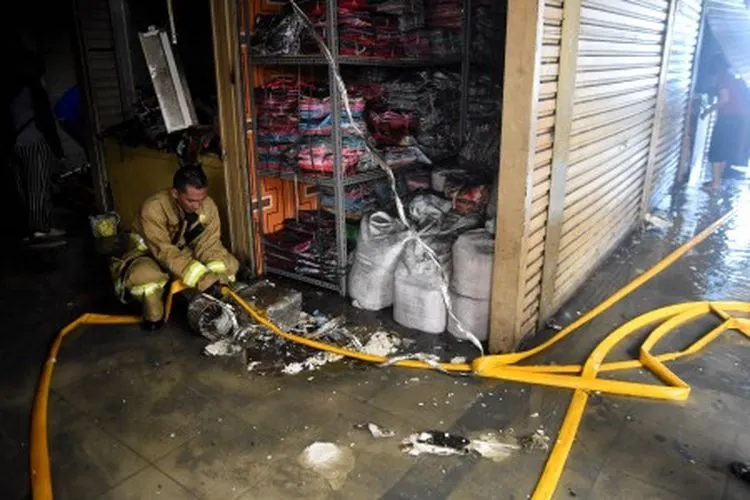 Petugas pemadam kebakaran menggulung selang pemadam usai melakukan pembasahan pada kebakaran yang terjadi di Gudang baju blok C Pasar Tanah Abang, Jakarta, Senin (22/4/2019). Sebanyak 20 unit mobil pemadam kebakaran dikerahkan untuk memadamkan api pada kebakaran yang terjadi di lantai 3 pasar tersebut. ANTARA FOTO/M Risyal Hidayat/aww.