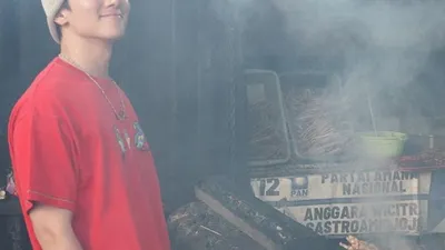 Aktor Ji Chang Wook terlihat berfoto di depan panggangan sate sambil tersenyum dalam unggahan postingan instagramnya.