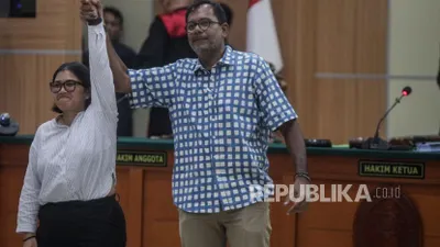 Terdakwa Haris Azhar (kanan) dan Fatia Maulidiyanti bergandengan tangan usai sidang vonis di Pengadilan Negeri Jakarta Timur, Senin (8/1/2024).
