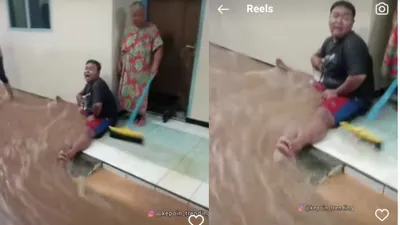 Seorang Pria Berusaha Menahan Banjir
