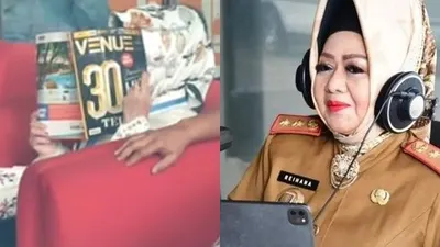 Reihana tutupi wajahnya dengan majalah saat berada di KPK.