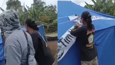 Aksi sekelompok orang mencabut label pada tenda bantuan yang diberikan tim berbagai dari rumah ibadah untuk korban gempa Cianjur