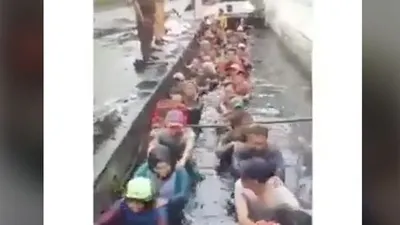 Tangkapan layar dari video yang merekam kegiatan para pegawai honorer DKI masuk ke selokan kotor di bawah pengawasan beberapa orang berpakaian PNS di kawasan Jelambar, Jakarta Barat.