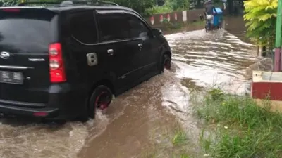 Sebuah mobil menerjang banjir di Kota Bekasi, Minggu (24/1/2021).[Dok/BPBD Kota Bekasi]