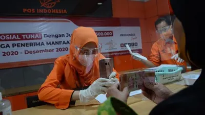 ilustrasi:bansos - Petugas memotret identitas penerima bantuan sebagai tanda bukti saat Penyaluran Bantuan Sosial Tunai (BST), di Kantor Pos, Jalan PHH Mustofa, Kota Bandung, Rabu (5/8/2020). BST dengan jumlah Rp 300.000 itu diberikan kepada Keluarga Penerima Manfaat (KPM).  Foto: Republika/Edi Yusuf