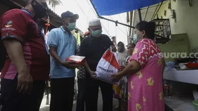 ilustrasi. Petugas memotret identitas penerima bantuan sebagai tanda bukti saat Penyaluran Bansos Tunai, di Kantor Pos  Foto: Edi Yusuf/Republika