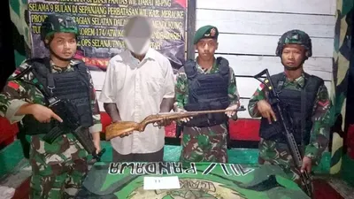 Penyerahan senjata api dan dua butir amunisi kaliber 22 kepada Satgas Pamtas TNI di Distrik Eligobel, Kabupaten Merauke, Papua, Minggu (23/2/2020). (Pasi Intel Satgas Yonif MR 411/Pdw Kostrad, Lettu Inf Asep Saepudin)