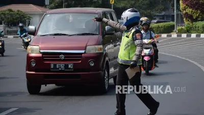 Petugas kepolisian mengamankan kendaraan roda empat di kawasan perluasan ganjil genap Jalan Majapahit, Jakarta, Senin (9/9/2019).  Foto: Thoudy Badai