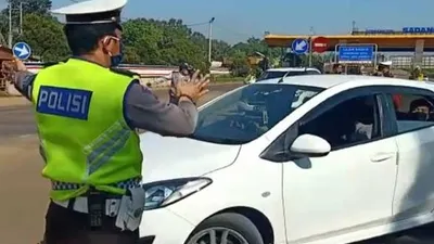 Petugas Kepolisian saat mengintruksikan kendaraan putarbalik di GT Sadang, Purwakarta. (dok)