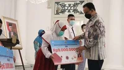 Gubernur DKI Jakarta, Anies Baswedan menyerahkan beasiswa pendidikan unutk anak tenaga eksehatan yang gugur karena Covid-19. (Sumber foto: Humas Pemprov DKI Jakarta)