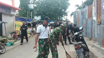Prajurit TNI bersih-bersih pasar (Dispen Kormar)