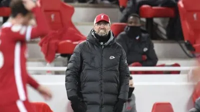 Reaksi manajer Liverpool Jurgen Klopp di pinggir lapangan saat menemani timnya menghadapi Burnley dalam laga lanjutan Liga Inggris di stadion Anfield, Liverpool, Jumat (22/1/2021) dini hari WIB. [PETER POWELL / POOL / AFP].