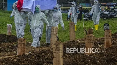 Sejumlah petugas membawa peti jenazah pasien Covid-19 di TPU Srengseng Sawah, Jagakarsa, Jakarta, Jumat (15/1). Pemerintah Provinsi DKI Jakarta membuka area pemakaman untuk jenazah COVID-19 di TPU Srengseng Sawah karena Taman Pemakaman Umum (TPU) khusus COVID-19 telah penuh. Republika/Putra M. Akbar