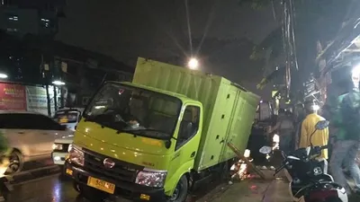 Truk bernomor polisi T 9452 AB  terjebak di Jalan Palmerah Barat III, Palmerah Jakarta Barat akibat jalan ambles bekas galian kabel listrik saat hujan di Jakarta, Selasa (8/10/2019)/Antaranews
