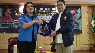 Kompol Vivick Tjangkung menerima plakat dari Dekan Fikom Moestopo Dr. Prasetya Yoga dalam kuliah umum menyambut mahasiswa baru/Fikom Moestopo