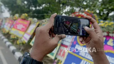 Warga memotret karangan bunga  Foto: Republika/Putra M. Akbar