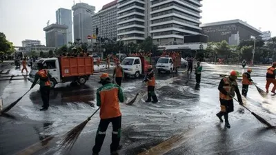 Petugas Penanganan Prasarana dan Sarana Umum (PPSU) membersihkan jalan pascakerusuhan di kawasan Kantor Bawaslu, Jakarta, Kamis (23/5/2019). ANTARA FOTO/Aprillio Akbar/foc.